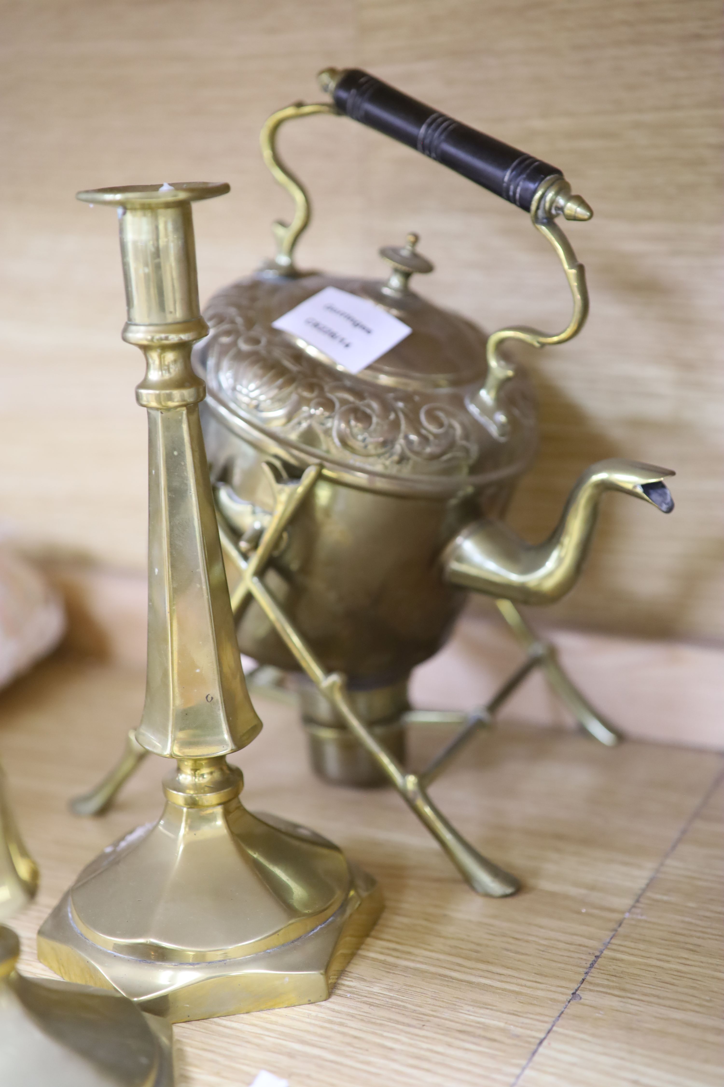 A Victorian brass spirit kettle on stand, two pairs of brass candlesticks and a jug